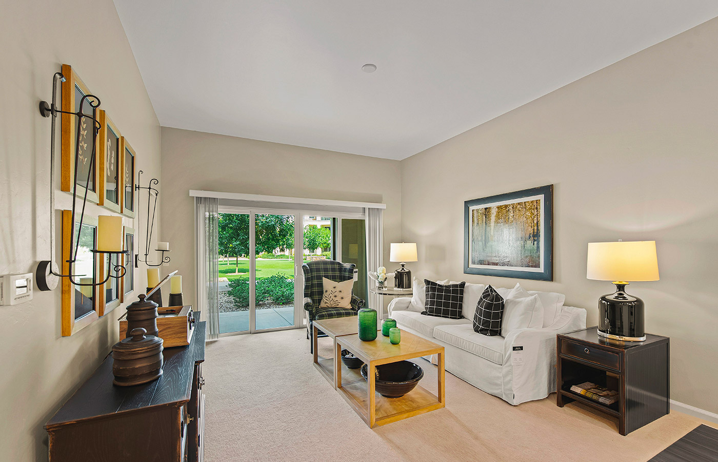 Furnished living room space with sofa, table, and seating area.