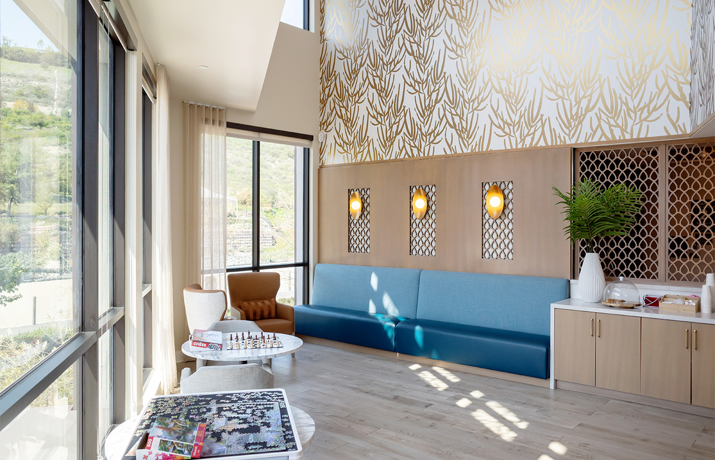 A seating area with a long blue couch.
