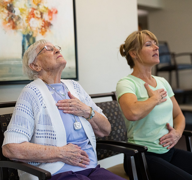 breathing-640x600 A resident is practicing their breathing exercises alongside their caregiver.