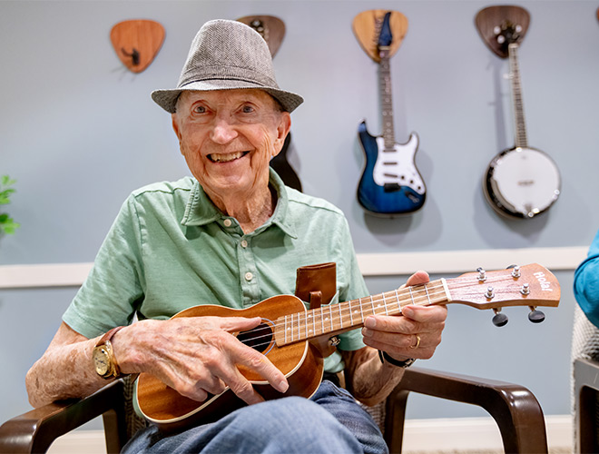 music-660x500 A person playing a guitar.