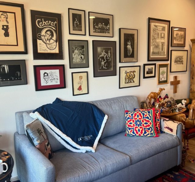 Living-Room-640x600 Living room with gray couch and photographs hanging on the wall.
