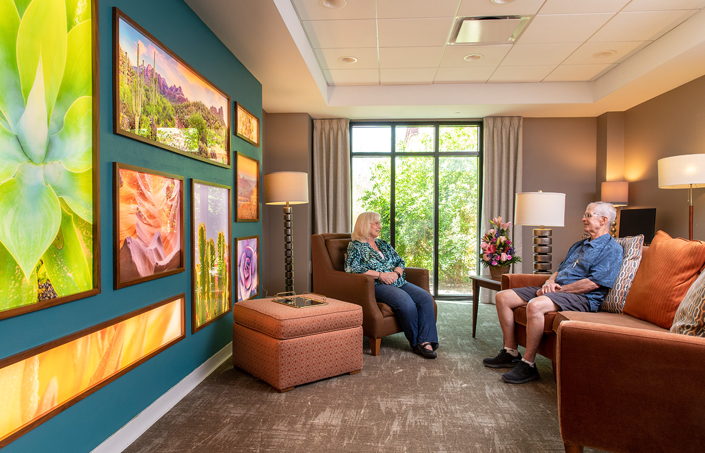 Two residents are sitting in chairs at The Watermark at Oro Valley.