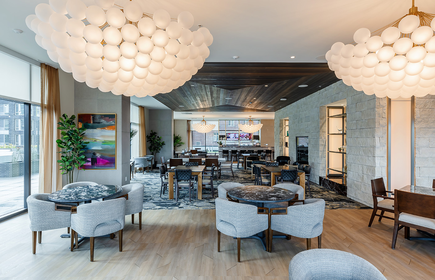 A lounge and bar with modern light fixtures.