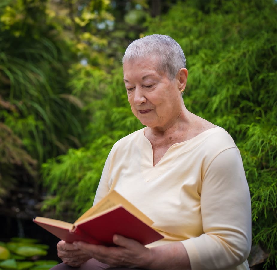 Mind A resident is reading a book outside.
