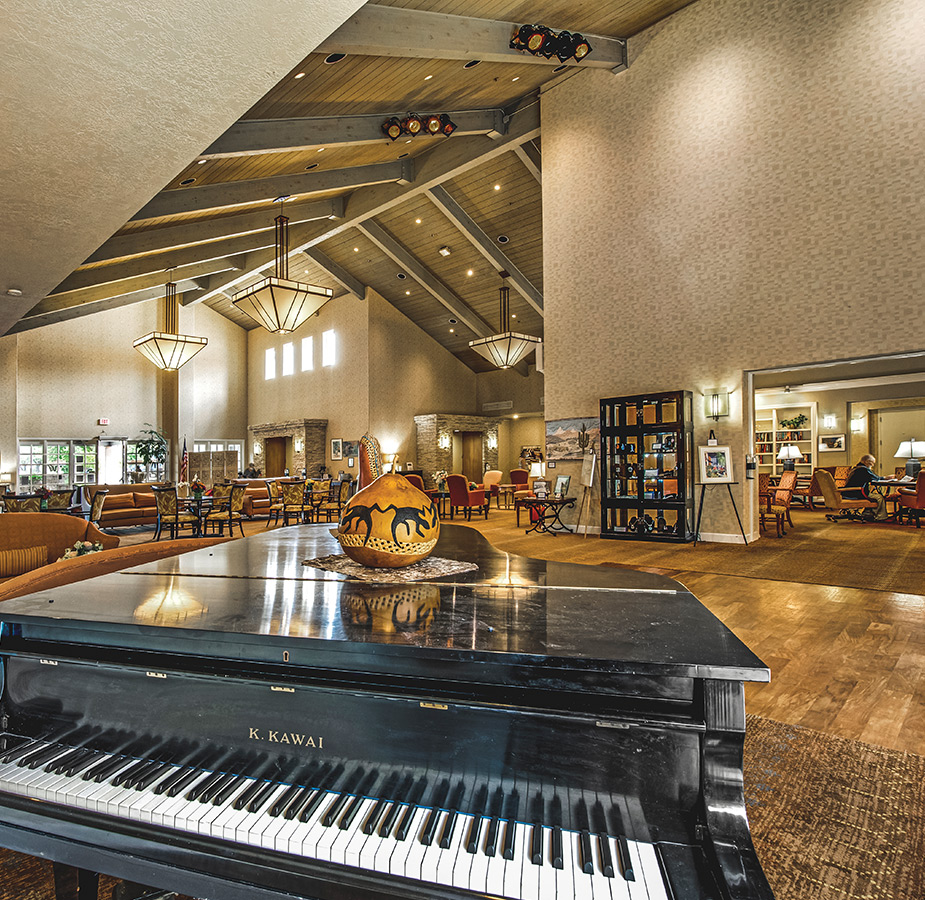 A classical piano in the common area at The Fountains at La Cholla.