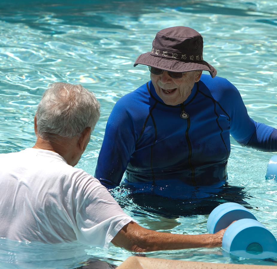 Move A resident is being assisted by a caregiver for water aerobics.