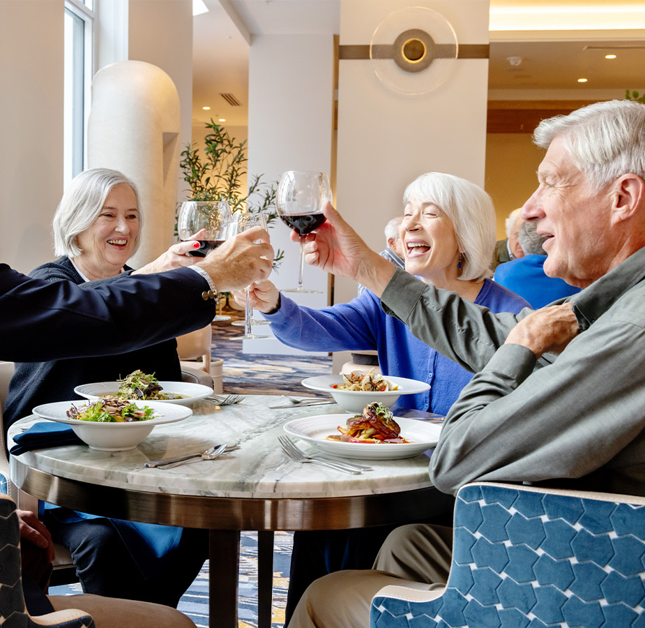 A group of friends dining and drinking wine.