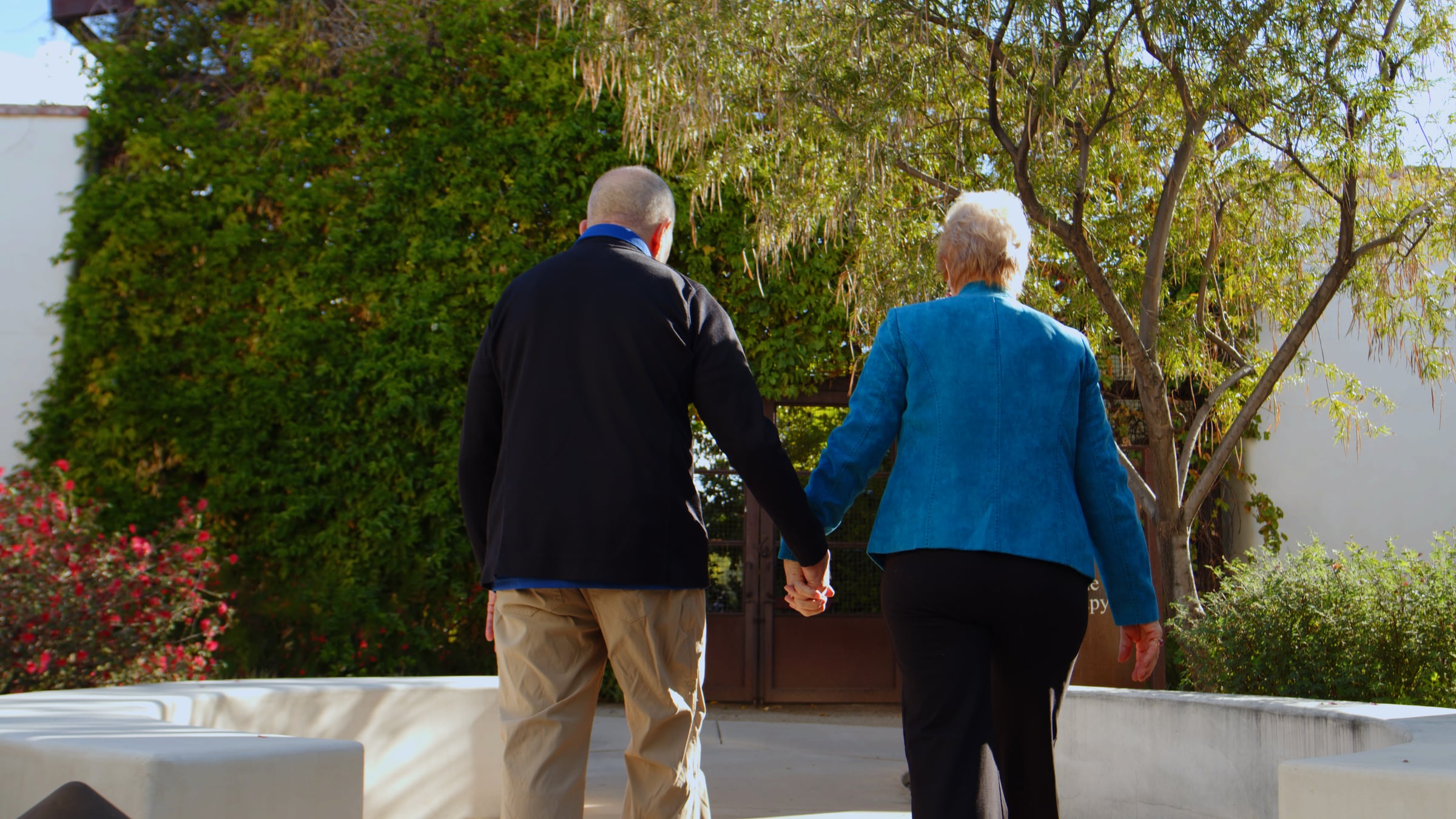 Mary-and-George A couple holding hands.