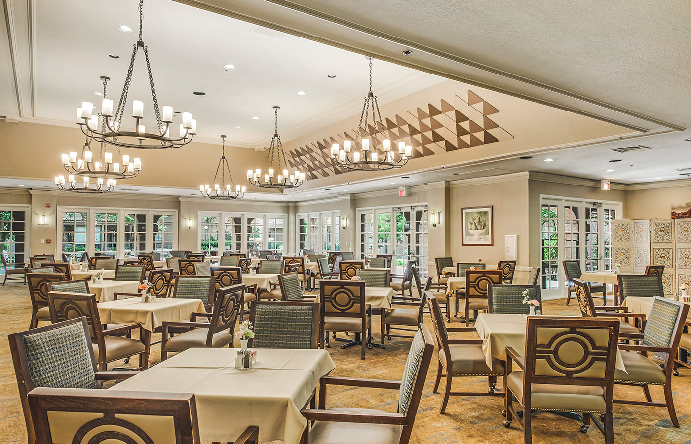 A dining room with tables and chairs.